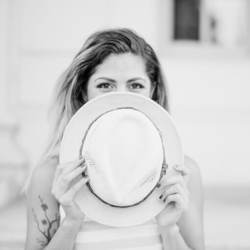 Woman hiding her face with a hat
